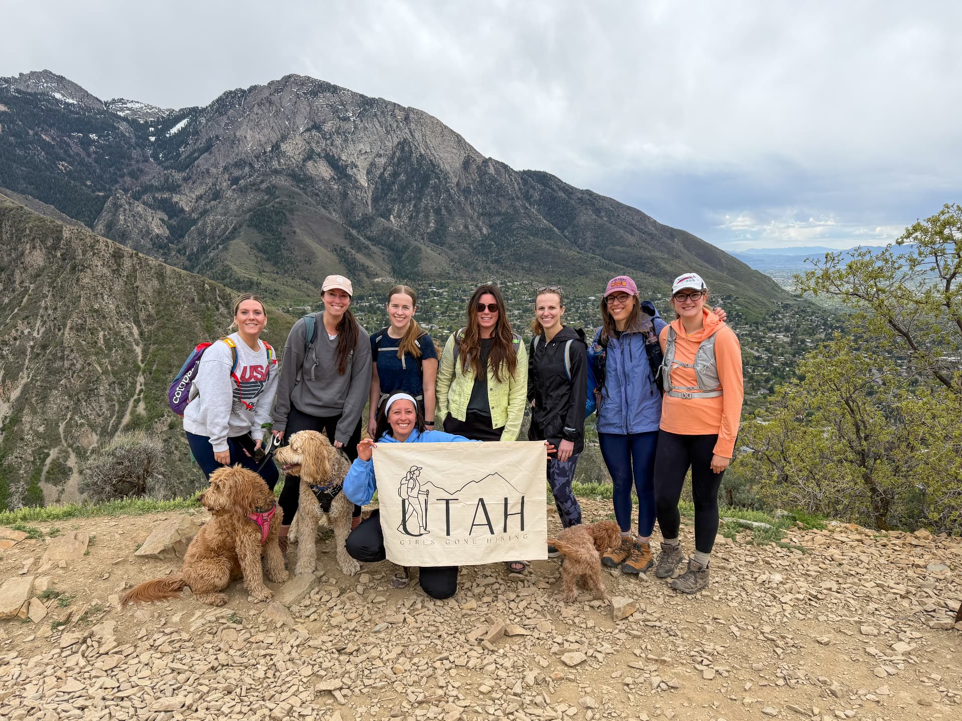Melanie Jeske with her Girls Gone Hiking group and their dogs on a mountain ridge